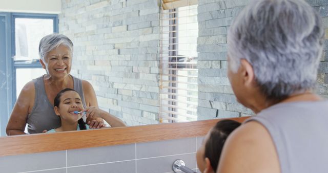 Senior Woman Assisting Child Brushing Teeth in Modern Bathroom Mirror - Download Free Stock Images Pikwizard.com