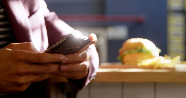 Person Using Smartphone in Fast Food Restaurant - Download Free Stock Photos Pikwizard.com