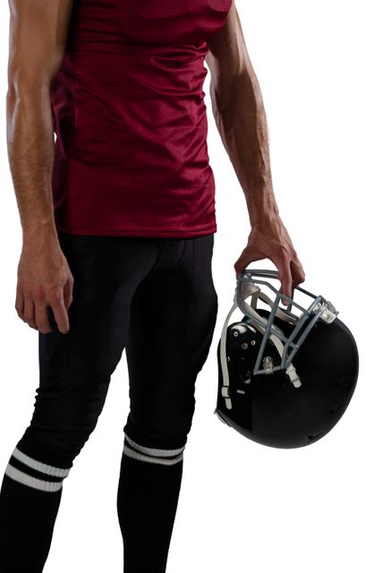Midsection of sportsperson holding helmet against white background