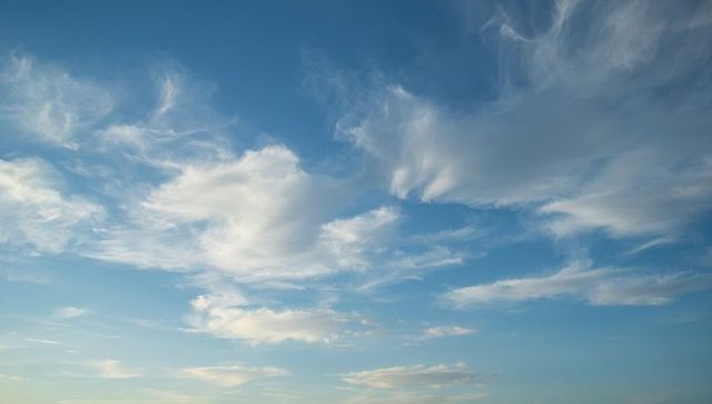 Serene Blue Sky with Wispy Cirrus and Cumulus Clouds