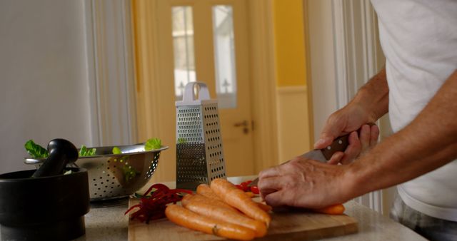 Person Cutting Fresh Carrots for Healthy Meal Preparation - Download Free Stock Images Pikwizard.com