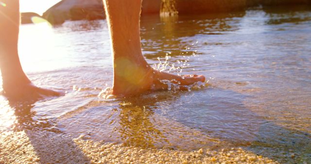 Close-Up of Feet in Water at Sunny Beach - Download Free Stock Images Pikwizard.com