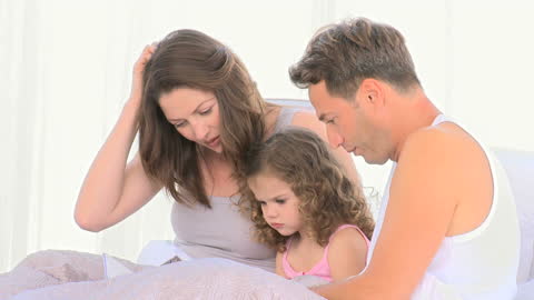 Loving Family Bonding While Reading in Bed