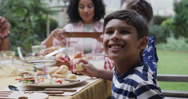 Smiling Boy Eating Family Outdoor Picnic - Download Free Stock Images Pikwizard.com