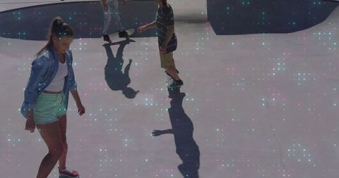 Teenagers skating in urban skatepark with dimensional art effect