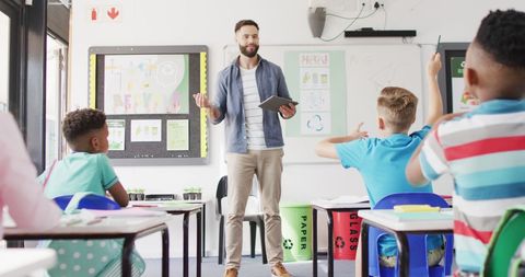 Enthusiastic Male Teacher Leading Interactive Classroom Lesson - Download Free Stock Images Pikwizard.com
