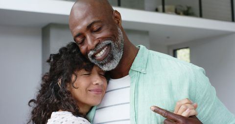 Smiling Biracial Couple Dancing Joyfully at Home
