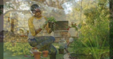 Kneeling woman potting seedlings in sunlit backyard with terracotta pots and watering can