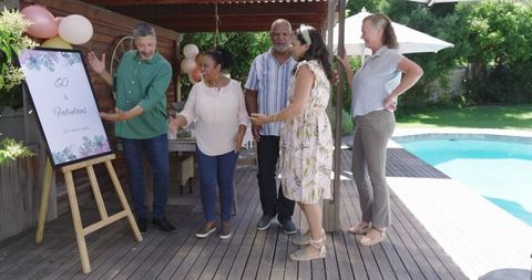 Diverse Seniors Celebrating 60th Birthday by Poolside