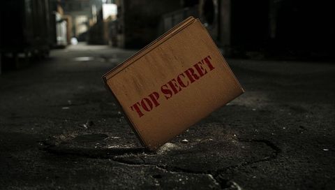 Tilting top secret box hovering above cracked warehouse floor in dim industrial corridor