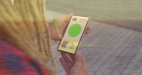 Woman Holding Smartphone with Digital Covid-19 Vaccine Passport - Download Free Stock Images Pikwizard.com