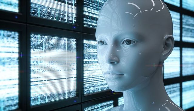 Glossy white humanoid head reflecting blue data streams across bank of digital displays