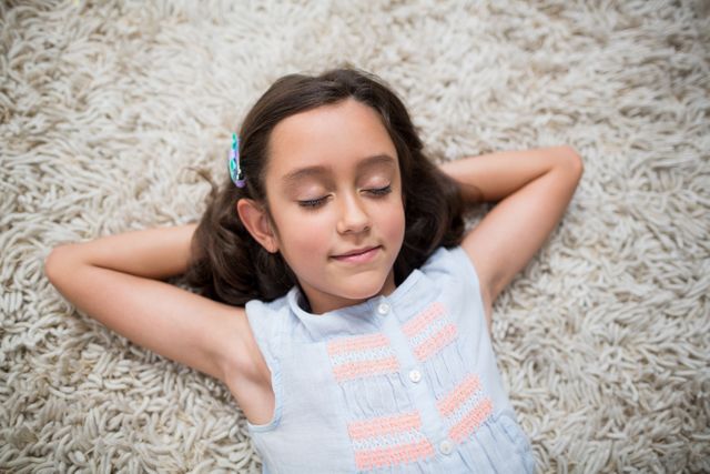 Girl sleeping on rug in living room at home