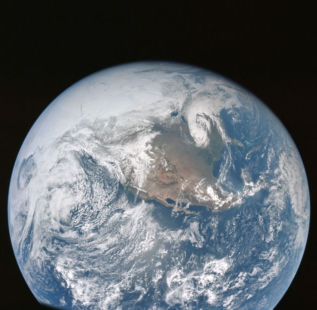 Blue and white Earth seen from outer space during Apollo 16 mission on April 16, 1972. Visible features include the United States, Mexico, Central America, the Great Lakes, and the Bahama Banks. Ideal for illustrating topics on space exploration, planetary science, and geography. Suitable for use in educational materials, scientific presentations, and astronomy-related articles.