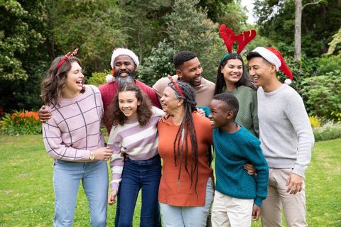 Diverse Family Celebrating Christmas Outdoors in Lush Garden