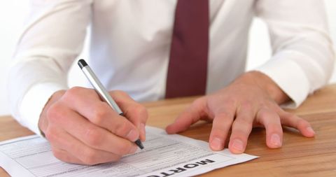 businessman signing mortgage contract on wooden desk - Download Free Stock Images Pikwizard.com