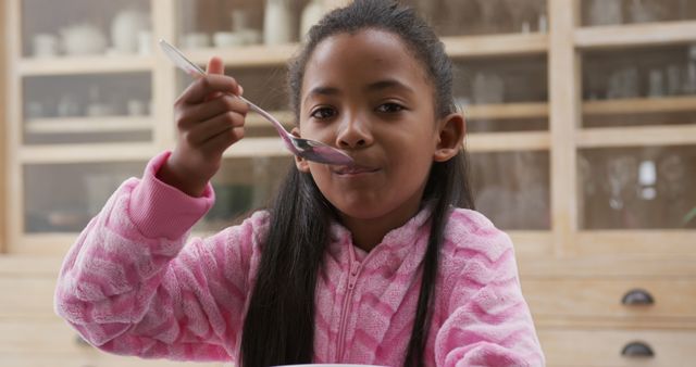 Young Girl Enjoying Breakfast in Comfortable Home Setting - Download Free Stock Images Pikwizard.com