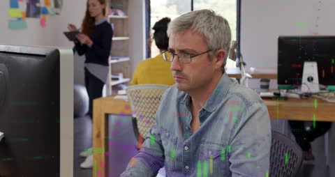 Middle-Aged Man Analyzing Financial Data in Modern Office