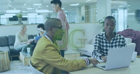 Team collaborating in modern open office workspace with technology