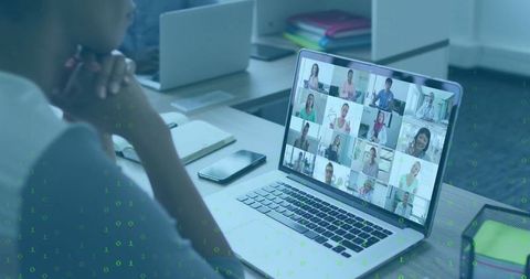 Asian Professional Engaged in Virtual Meeting on Laptop in Modern Office