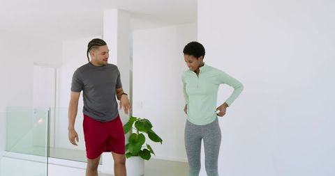 Diverse Friends Adjusting Workout Clothes Indoors