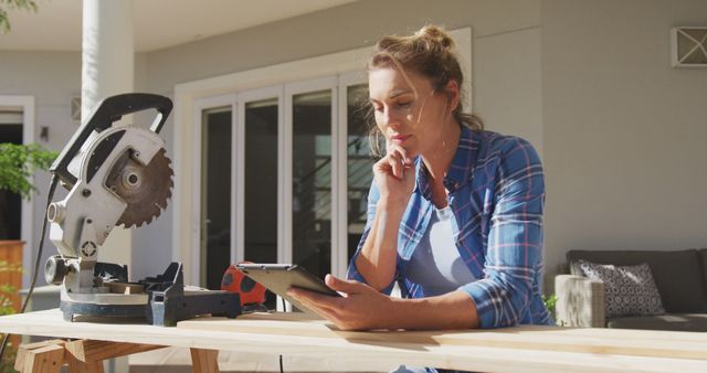 Woman Working on DIY Project Using Tablet for Instructions Outdoors - Download Free Stock Images Pikwizard.com