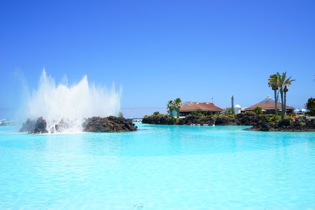 Scenic View of Tropical Beach Resort with Large Fountain in Clear Blue Waters Embrace - Download Free Stock Photos Pikwizard.com