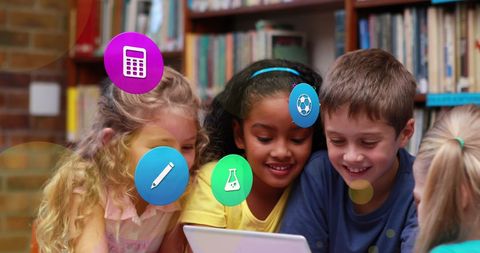 Diverse children collaborating on tablet with educational icons overlay