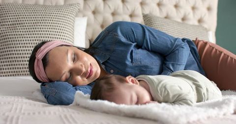 Mother and Baby Sleeping Peacefully on Bed