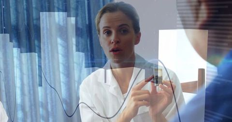 Doctor explaining health sensor with data visualization overlays