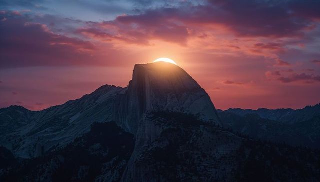 Sunrise behind granite monolith in pristine wilderness