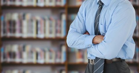 Businessman in Blue Shirt Standing in Library - Download Free Stock Images Pikwizard.com