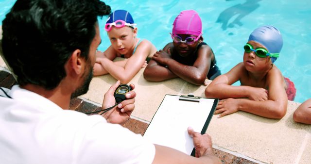 Competitive Swim Coach Timing Children During Swimming Practice - Download Free Stock Images Pikwizard.com