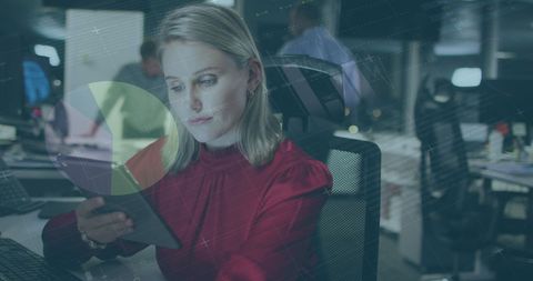 Woman using digital tablet with data visualization at office