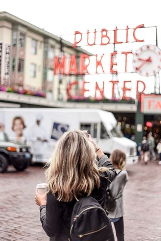 Tourist capturing moments at public market center