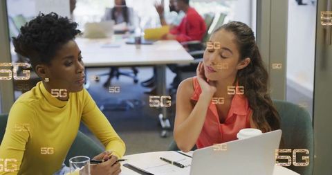 Colleagues Discussing Digital Strategies in Modern Office