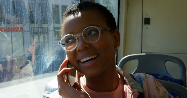 Happy Young Woman Talking on Phone While Traveling on Bus - Download Free Stock Images Pikwizard.com