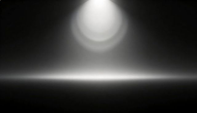 Casting overhead spotlight with halo and thin illuminated horizon on empty monochrome studio stage
