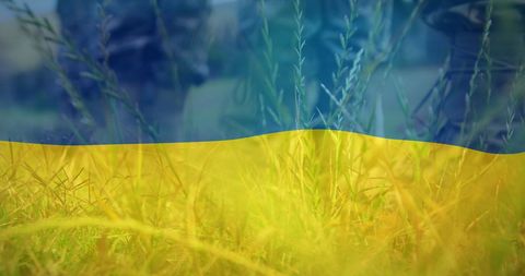 Ukrainian Flag with Military Boots in Grass