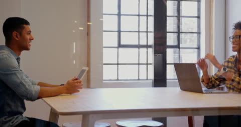 Colleagues Collaborating Near Window With Technology