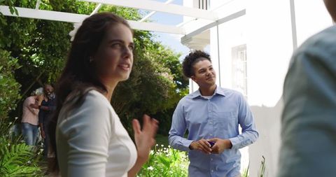 Guests Mingling Amidst Greenery at Elegant Garden Wedding