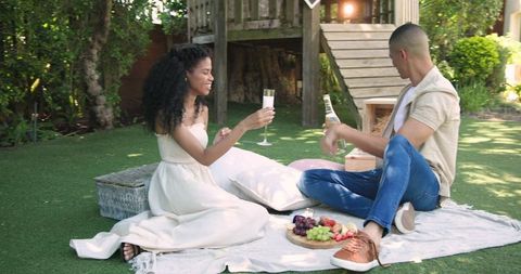 Romantic Picnic with Couple Sharing Drinks and Fruit Outdoors