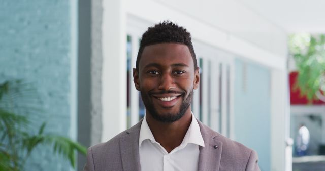 Confident Young Businessman in Stylish Suit, Bright Smile on Clean Background - Download Free Stock Images Pikwizard.com