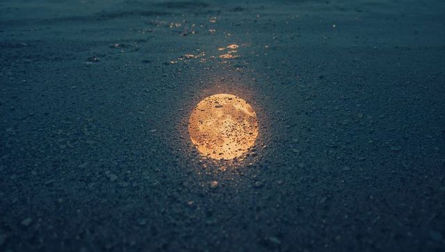 Reflective Light on Wet Urban Asphalt at Night
