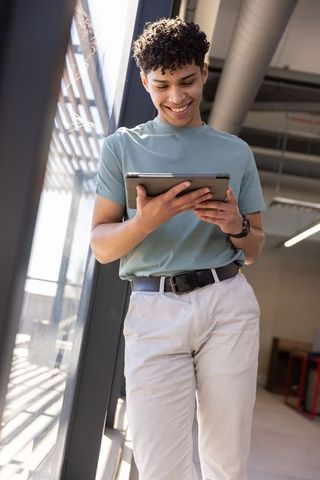 Modern Professional Checking Tablet in Daylit Office Space