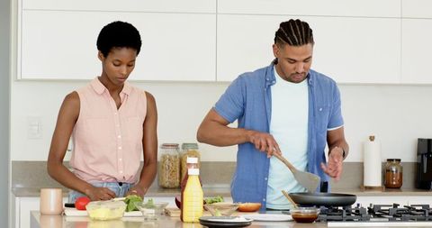 Couple Preparing Meals in Modern Kitchen While Cooking Together