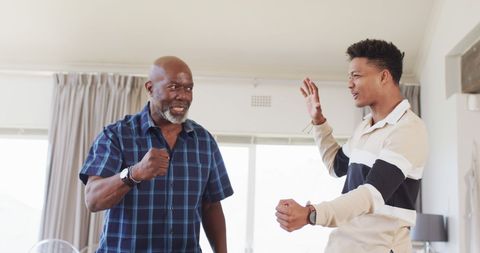 Excited African American Father and Son Enjoying Sports Victory