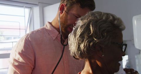 Doctor Examining Senior Patient During COVID-19 at Retirement Home