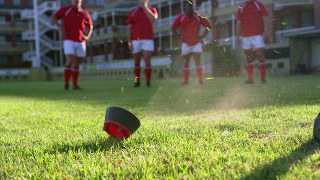 Scene captures precise moment rugby player kicks ball from tee in stadium. Highlighting intense focus and dynamic action in rugby sporting events, image is ideal for promoting fitness, teamwork narratives, or educational materials on rugby rules.