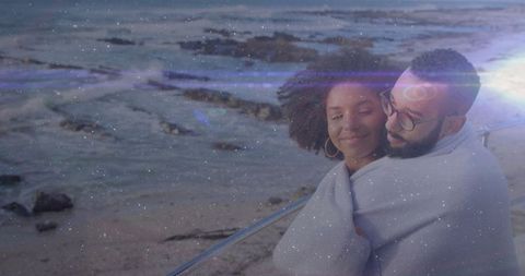 Romantic Cuddling Couple Embracing by Ocean Waves at Sunset